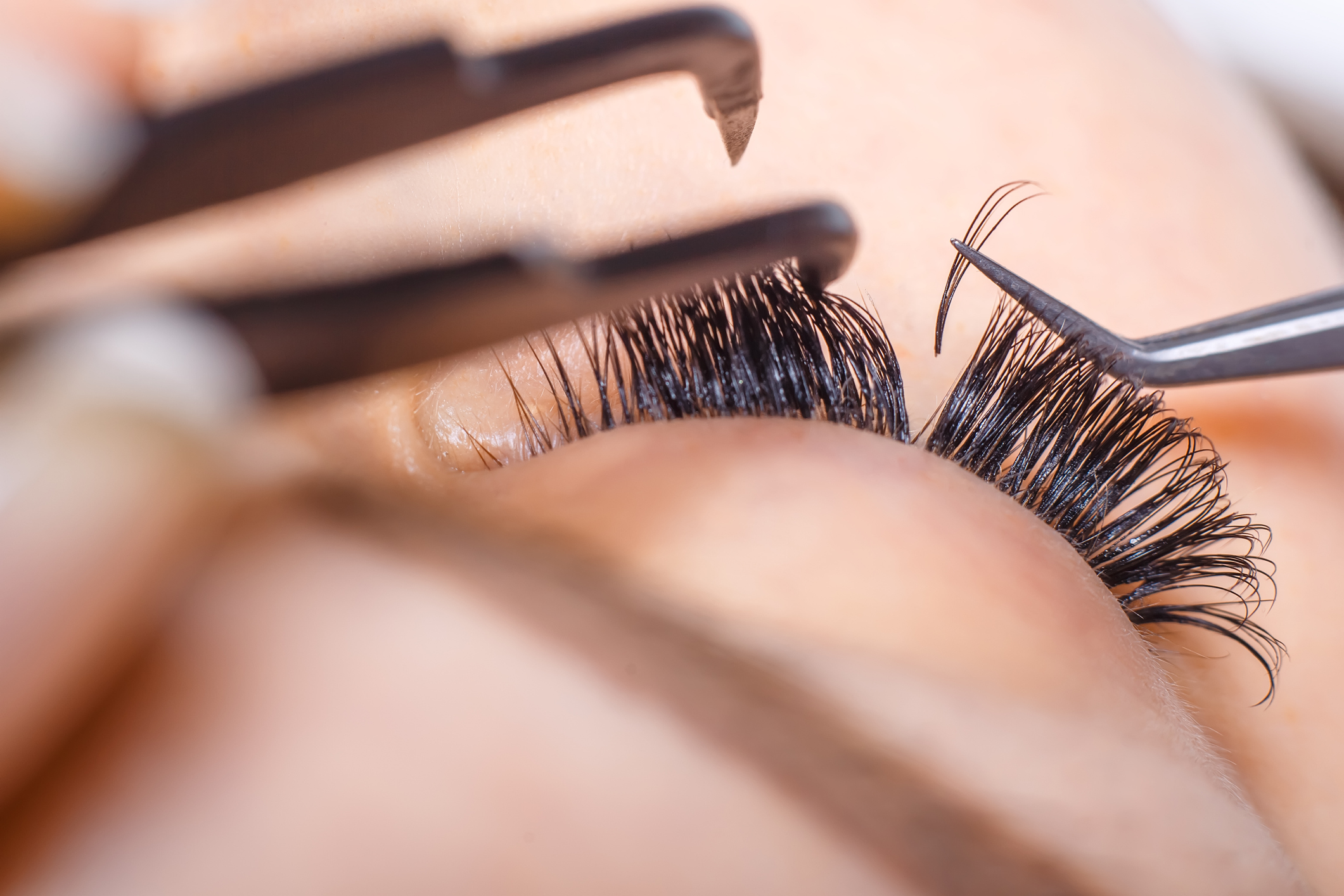 Eyelash Extension Procedure. Woman Eye with Long Eyelashes. Lashes. Close up, macro, selective focus